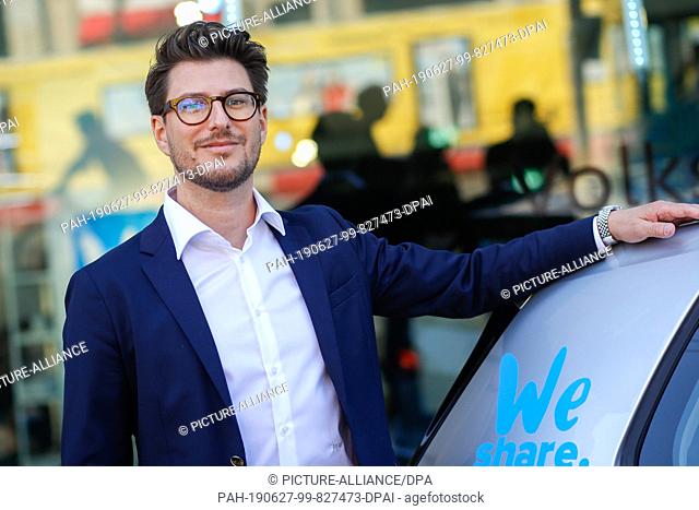 27 June 2019, Berlin: Philipp Reth, CEO of WeShare, stands next to a Volkswagen E-Golf after the press conference. VW launches its own car sharing service in...