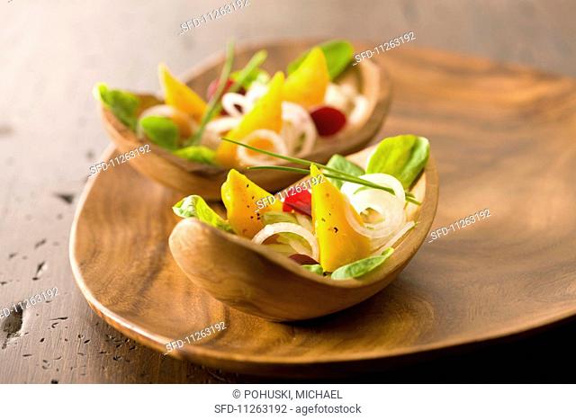 Golden beet salad in wooden bowls