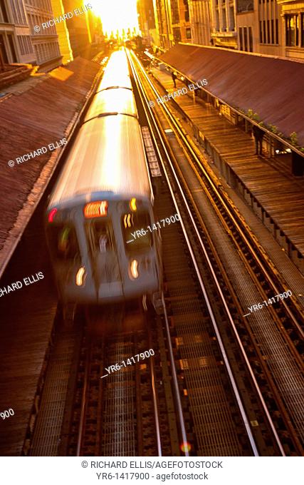 Sunrise illuminates a train in the Chicago rapid transit system known as the'L' in Chicago, IL, USA