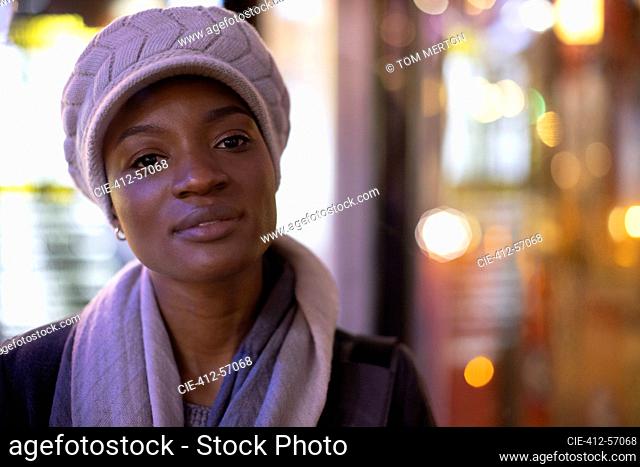 Portrait confident young woman in hat and scarf