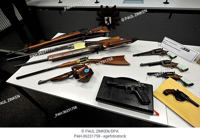 Seized rifles, handguns and ammunition lie on a table at the police headquarters at Platz an der Luftbruecke in Berlin, Germany, 16 January 2013