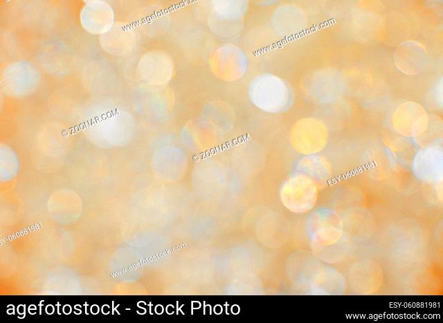 Abstract background of golden and silver bokeh defocused blurred lights and glitter sparkles