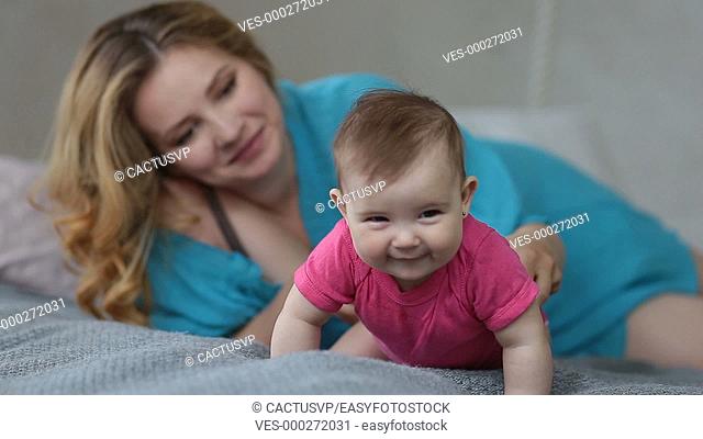 Adorable infant baby crawling on bed