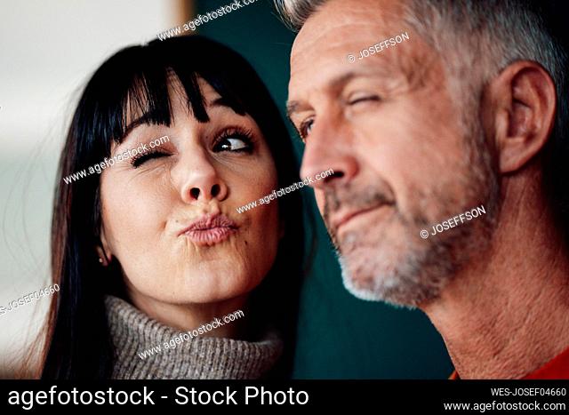 Mature couple making faces at cafe