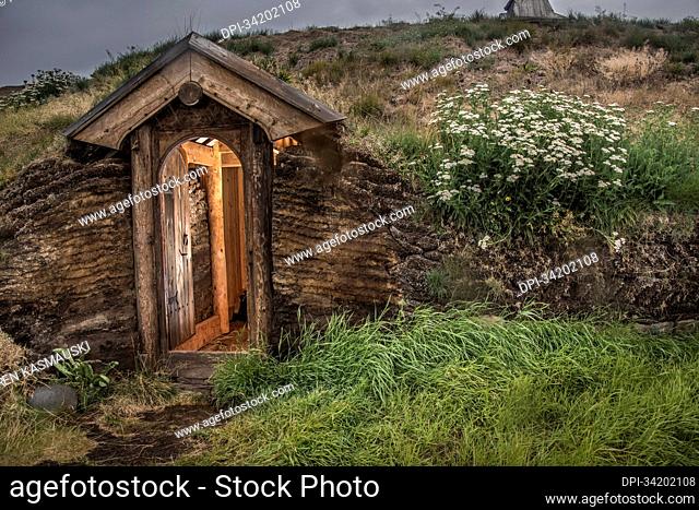Stone and turf structure with wooden doorway at the recreated longhouse in Greenland's Brattahlid, Eriksfjord area, part of a reconstruction of Erik the Red's...
