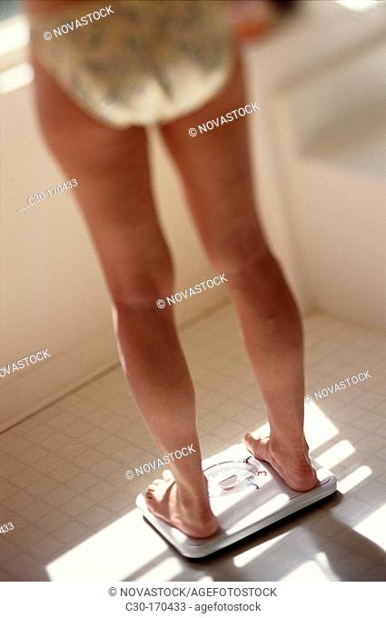 Woman on bathroom scales