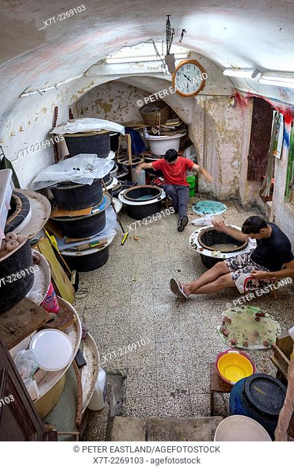 Fishermen preparing their fishing lines in a fishermens den in the old town of Gallipoli, Puglia, Southern Italy