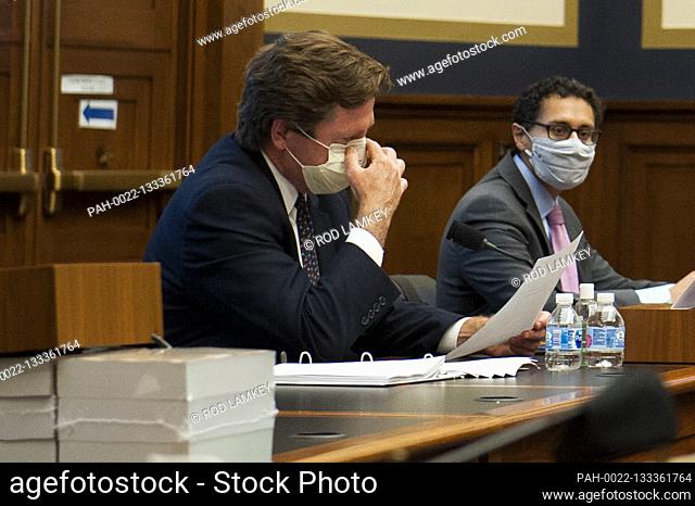 U.S. Securities and Exchange Commission Chairman Jay Clayton adjusts his protective mask as he testifies before a House Committee on Financial Services hearing...