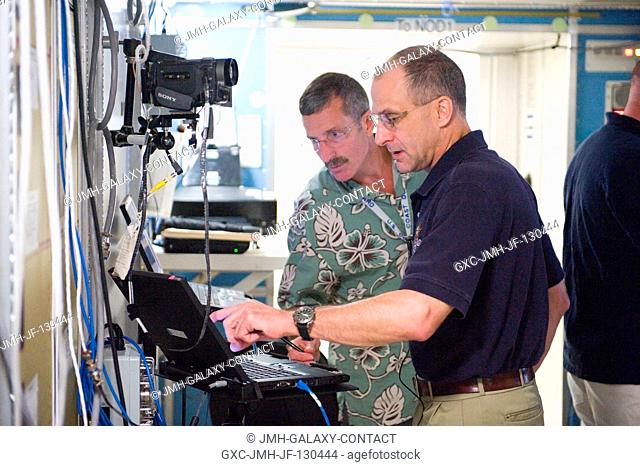 NASA astronaut Dan Burbank, Expedition 29 flight engineer and Expedition 30 commander; NASA astronaut Don Pettit (foreground) and European Space Agency...