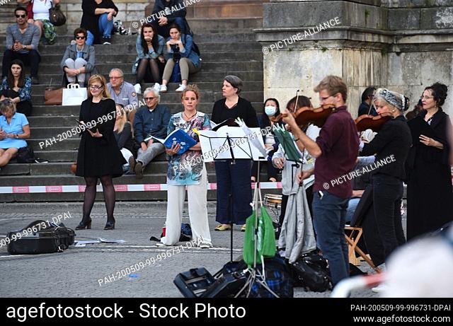 08 May 2020, Bavaria, Munich: Musicians play and sing at a meeting on Munich's Odeonsplatz, with which they want to draw attention to the situation of freelance...