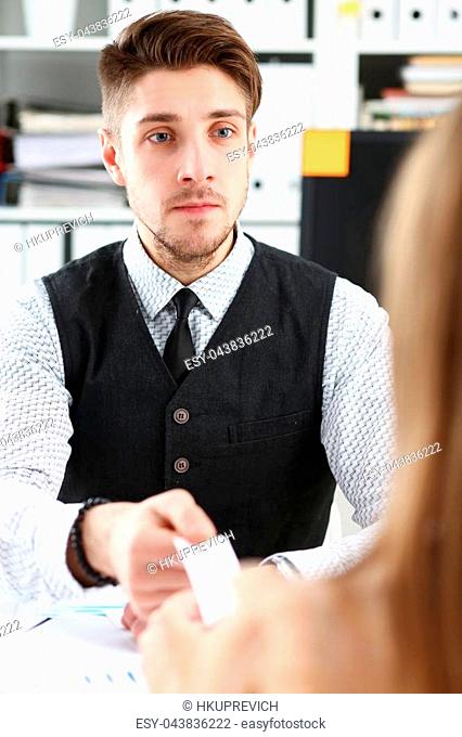 Male hand in suit give blank calling card to female visitor portrait. White collar partners company name exchange executive or ceo introducing at conference...