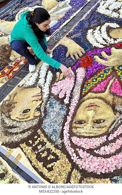 female artist making composition with flower petals and seeds at infiorata of genzano province of roma italy europe