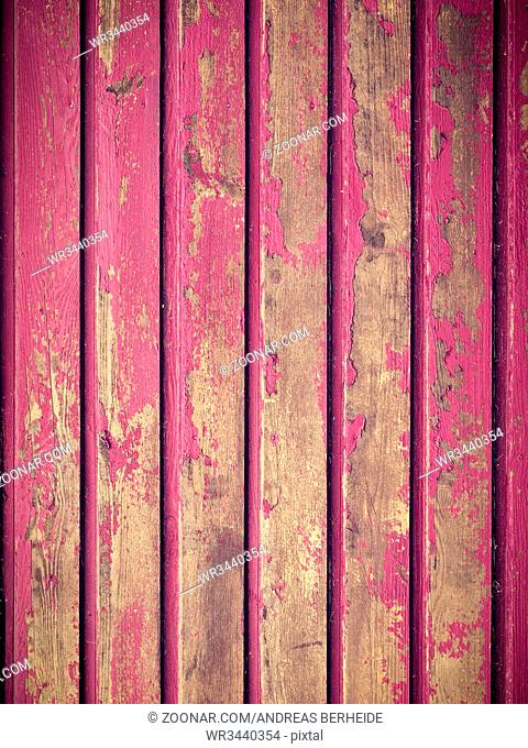 Texture of peeling paint on a rustic wooden wall