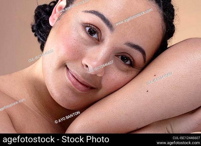 Studio portrait of smiling woman