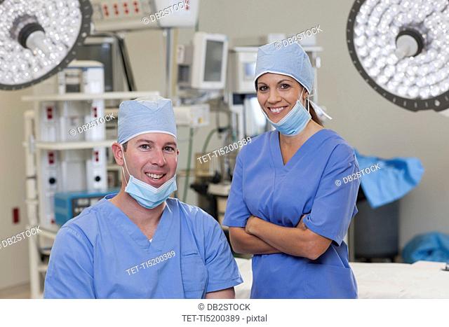 Portrait of male and female surgeons in operating room