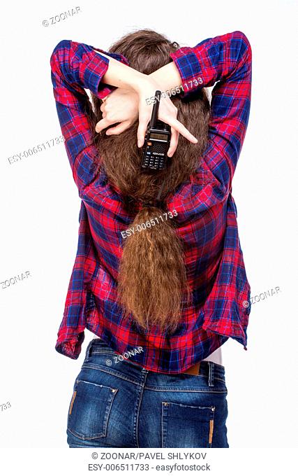 Attractive young woman in a checkered shirt with walkie talkie