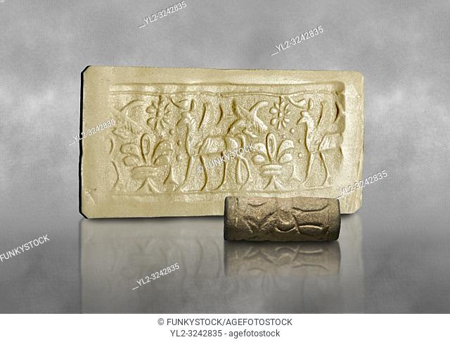 Hittite cylinder seal depicting a scene of animals, seal in foreground and impression standing behind. . Adana Archaeology Museum, Turkey