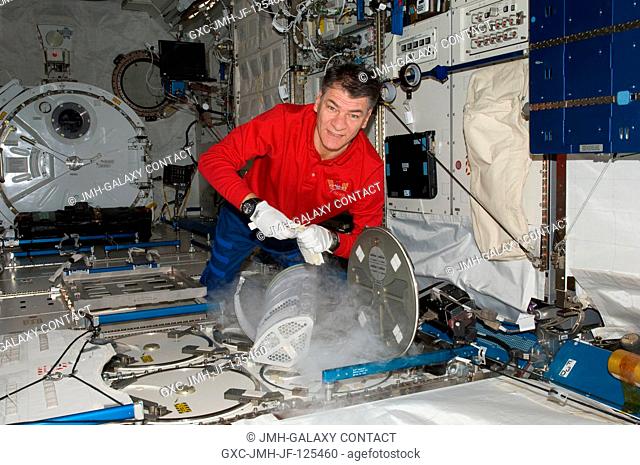 European Space Agency astronaut Paolo Nespoli, Expedition 26 flight engineer, services the Minus Eighty Laboratory Freezer for ISS (MELFI-1) in the Kibo...