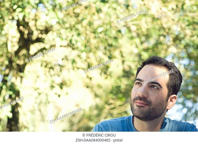 Man daydreaming outdoors