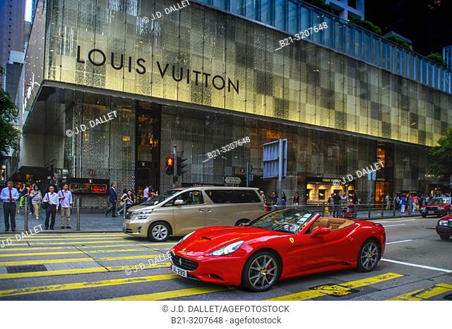 Luxury car in front of Louis Vuitton shop. Central Hong Kong. China