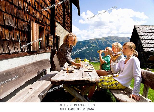 family having picnic at mountain hut