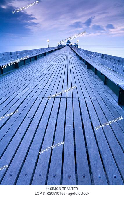 England, Somerset, Clevedon. Twilight view along the boardwalk towards the end of Clevedon Pier, the only fully intact, Grade 1 listed pier in the country