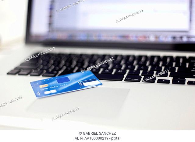 Credit card resting on laptop computer
