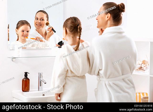 happy mother and daughter in bathroom