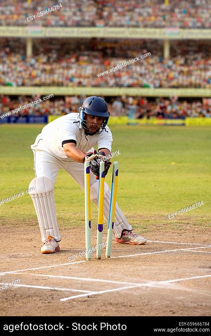 Wicketkeeper catching a throw at the stumps During a match in the stadium