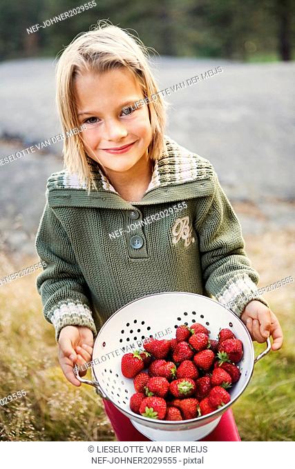 Girl showing strawberries