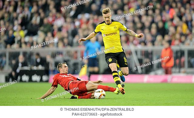 Munich's Philipp Lahm (L) and Dortmunds's Marco Reus in action during the Bundesliga soccer match FC Bayern Munich vs Borussia Dortmund in Munich, Germany