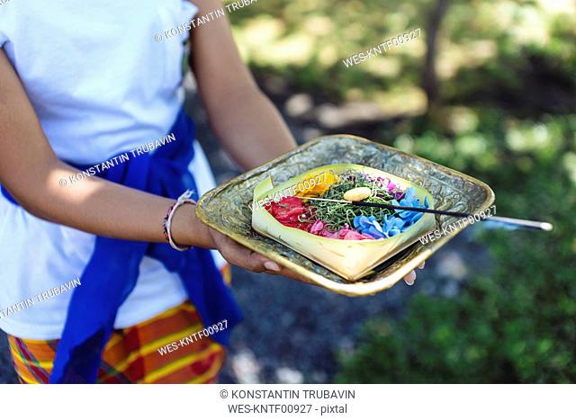 Woman holding Balinese offering