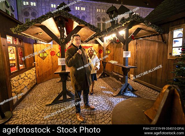 19 December 2023, Bavaria, Munich: Markus Söder (CSU), Prime Minister of Bavaria, strolls through the Christmas market in the ""Kaiserhof"" of the Munich...