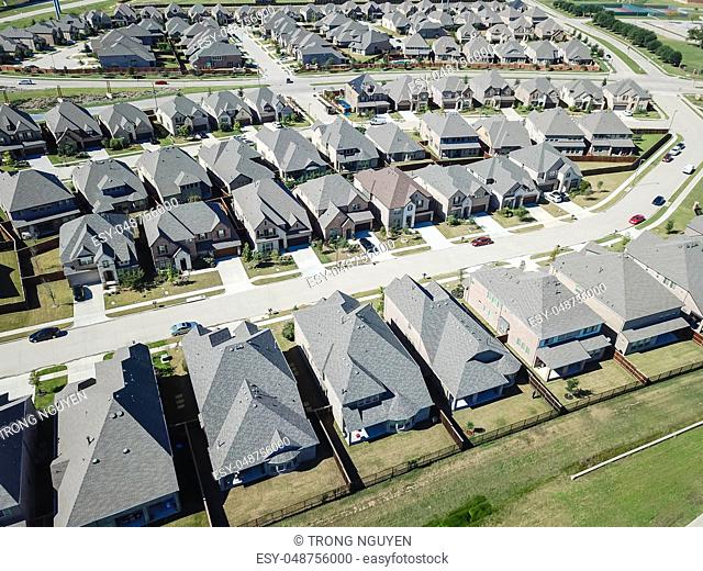 Aerial view new development community with row of detached single-family house and garden. Flyover residential area suburban Dallas, Texas, USA