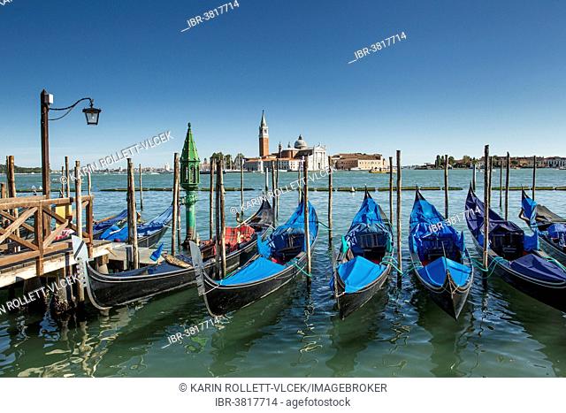 Gondolas at the Riva degli Schiavoni, San Giorgio Maggiore at the back, Venice, Italy