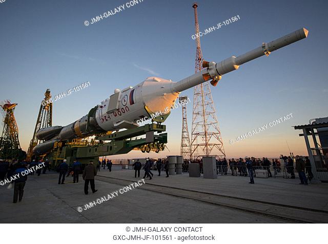 The Soyuz rocket is ready to be erected into position after being rolled out to the launch pad by train, on Sunday, October 21, 2012