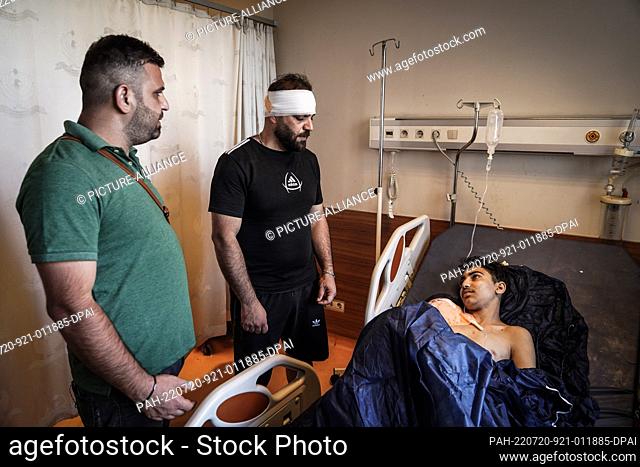 20 July 2022, Iraq, Zakho: An injured young man lies in hospital in Zakho city after a Turkish shelling on a tourist resort in northern Iraq