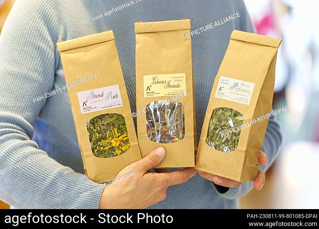 PRODUCTION - 03 August 2023, Hesse, Fulda: The self-produced herbal tea blends ""Abend Ruh"" (l-r), ""Lebensfreude"" and peppermint are presented in the...