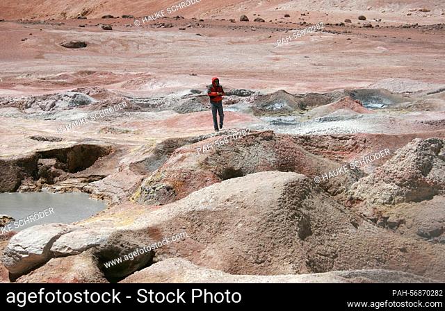 A tourist on a jeep tour during a rest in the geyser field «Sol de Manana» on October 15, 2009. The geyser field, which lies in the Andes Altiplano between the...