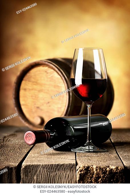 Red wine and wooden cask on a table