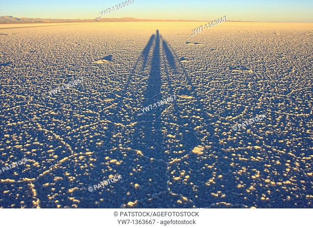 Shadow of a biker on the frozen salt lake called 'Salar de Uyuni' in Bolivia