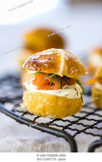 Savoury Hot Cross Bun burger with salmon and cream cheese