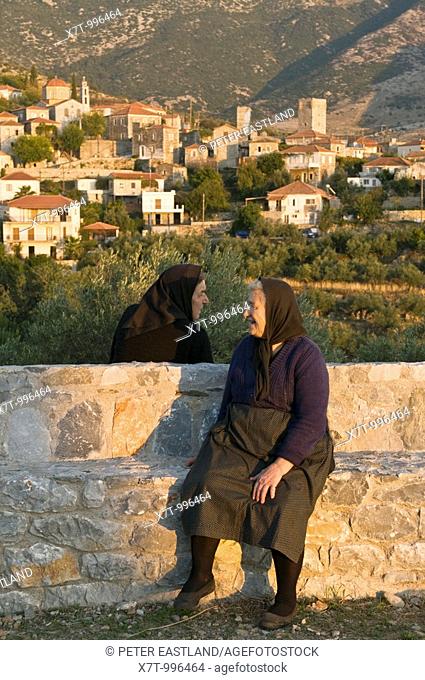 Two villagers chatting in the evening light in the Outer Mani village of Langada, in the the foothills of the Taygetos mountains, Southern Peloponnese, Greece