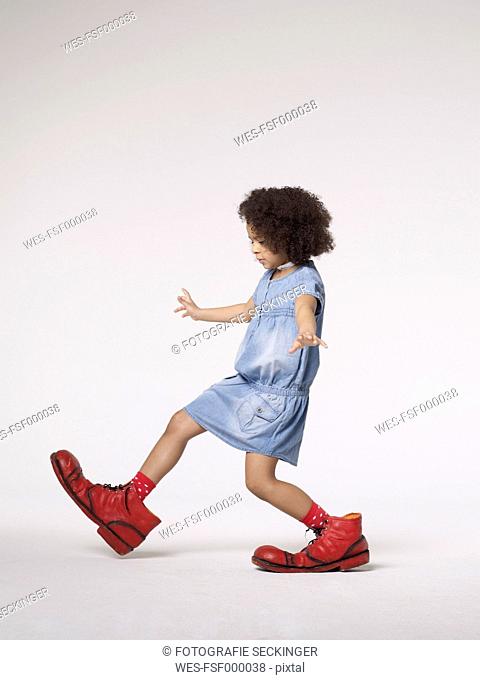 Girl walking in large clown shoes