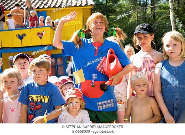 Actress impersonating Pippi Longstocking interacting with kids at the Villa Villekulla, Astrid Lindgren's World amusement park, Vimmerby, Sweden, Scandinavia