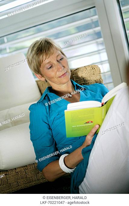 Mature woman reading a book, Styria, Austria