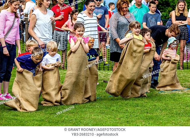 Children Race In A Traditional Sack Race At The Medieval Fair Of Abinger, Surrey, UK