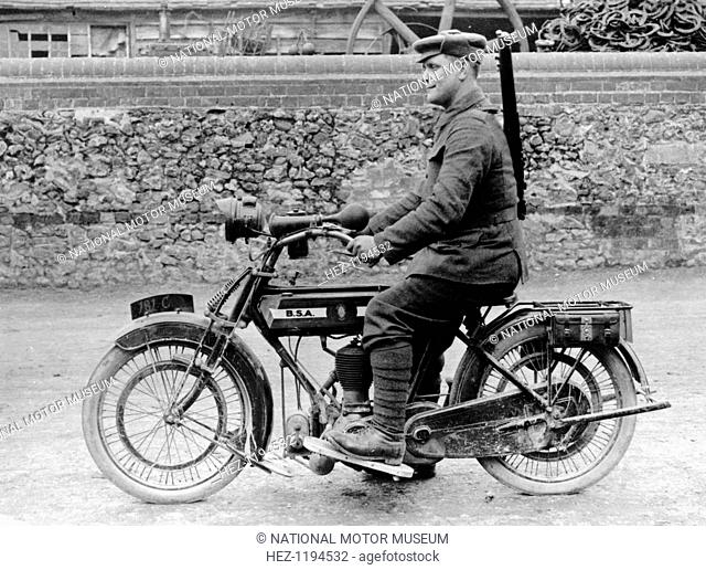 1918 500cc BSA WD motorcycle, (c1918?). A soldier is riding the machine, his rifle over his shoulder