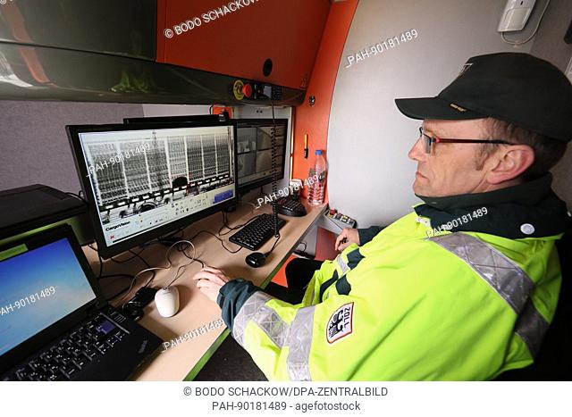 A customs officer sits in front of an evaluation monitor on a Customs mobile X-ray device at a rest area of the Autobahn 9 near Schleiz, Germany, 26 April 2017