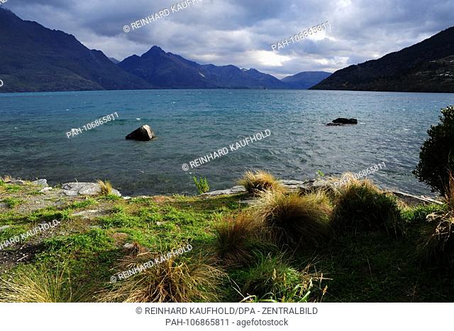 The Lake Wakatipu near Queenstown on the South Island of New Zealand - in the background the foothills of the Suedalpen, recorded in April 2018 | usage...